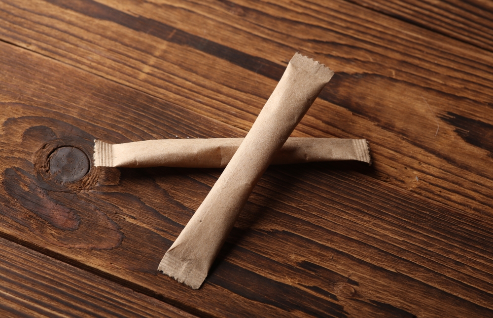 Packages,Of,Single-serve,Coffee,Or,Sugar,On,Wooden,Background